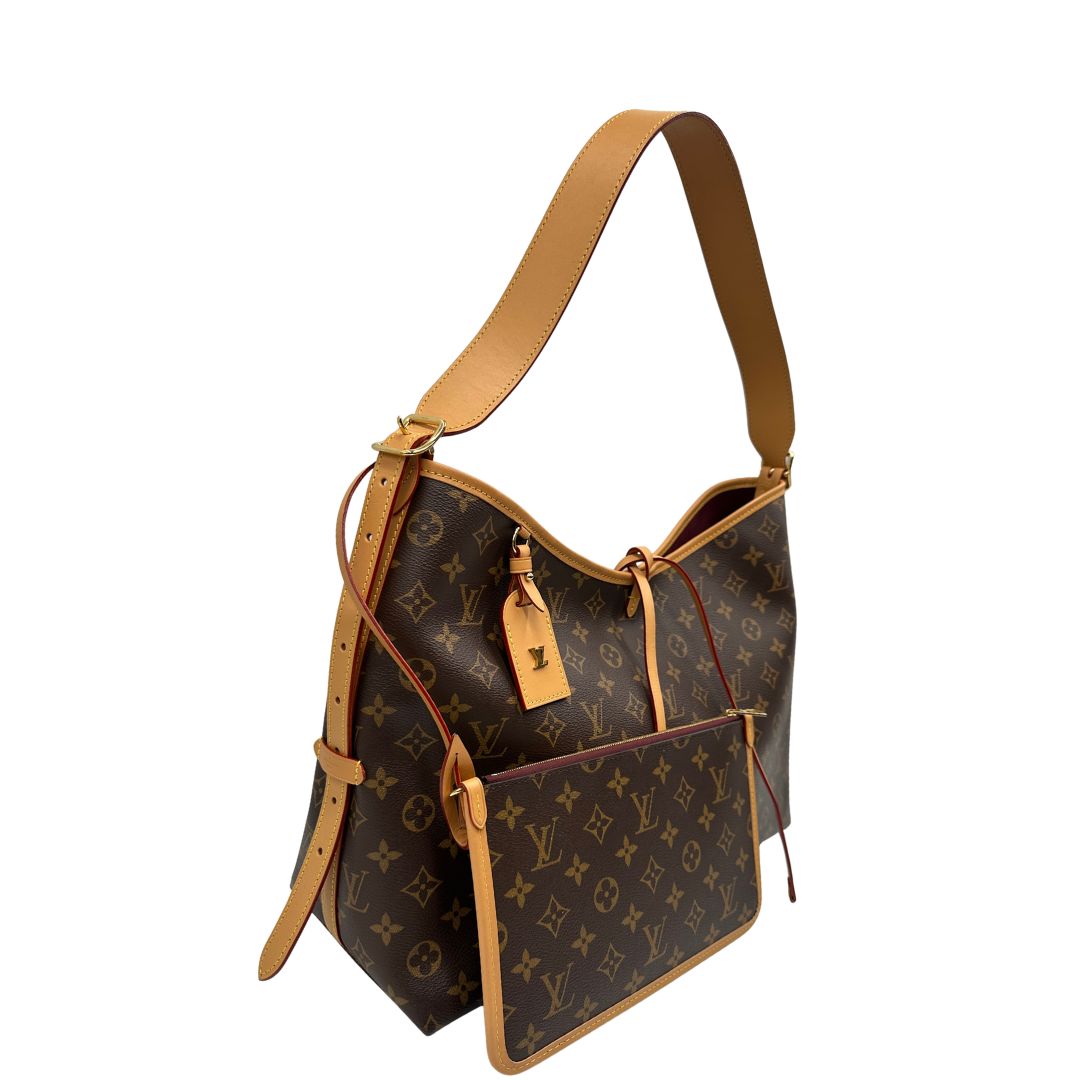 lato  La borsa CarryAll MM è realizzata in tela Monogram e rifinita in pelle naturale, di lusso, originale, ottime condizioni, usata. 