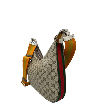 Lato sinistro, Borsa Gucci Attache in canvas beige con tracolla Web arancione e verde. Originale, usata, di lusso, in condizioni eccellenti.