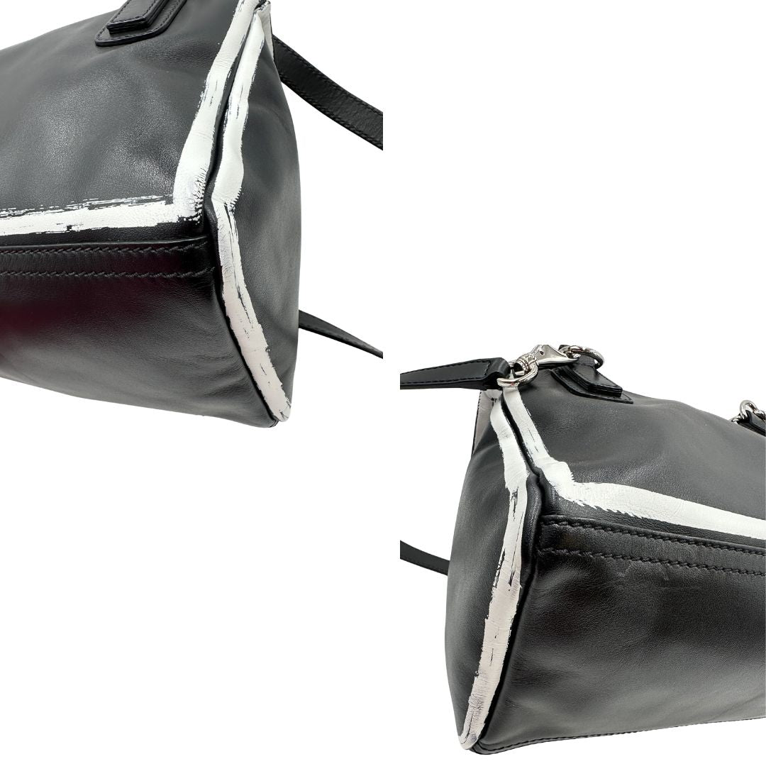 angoli della  Compatta borsa Givenchy in pelle nera con maxi logo sul front, di lusso, originale, ottime condizioni, usata. 