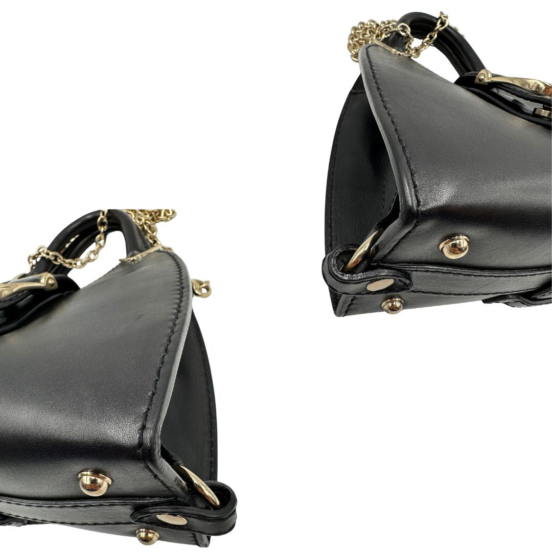 angoli  Borsa Stirrup Gucci in pelle nera, indossabile a mano o a tracolla, di lusso, originale, ottime condizioni, usata. 