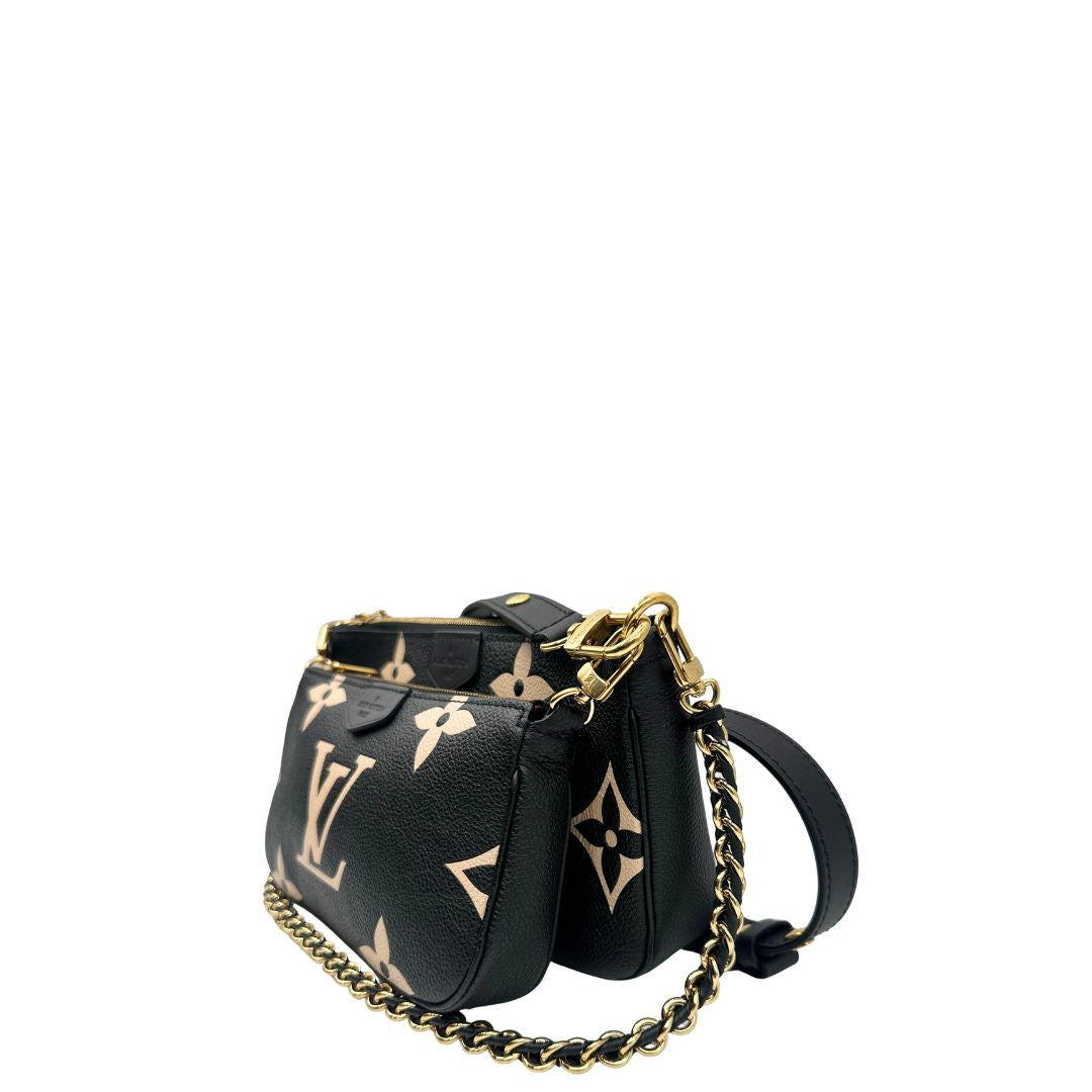 lato  Borsa LV in pelle monogram empreinte nera e beige, di lusso, eccellenti condizioni, usata. 