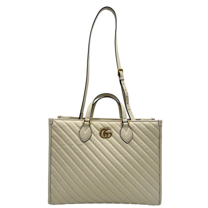 front Borsa Gucci in pelle bianca con logo GG in metallo dorato sul front, di lusso, originale, ottime condizioni, usata. 