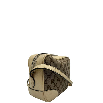 lato  Camera Bag Gucci in tessuto GG con finiture in pelle color avorio, di lusso, originale, ottime condizioni, usata. 