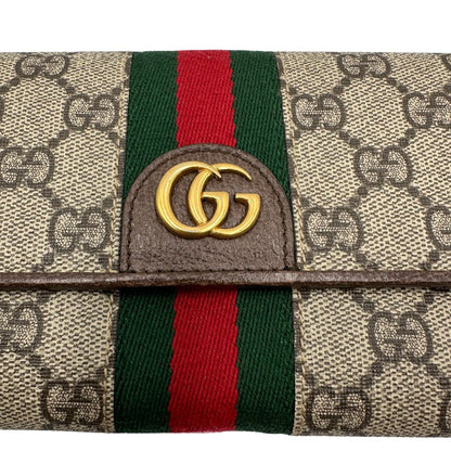 Portafoglio Gucci in canvas beige GG con iconica striscia Web, sul retro presenta stampa Disney, di lusso, originale, ottime condizioni, usato.