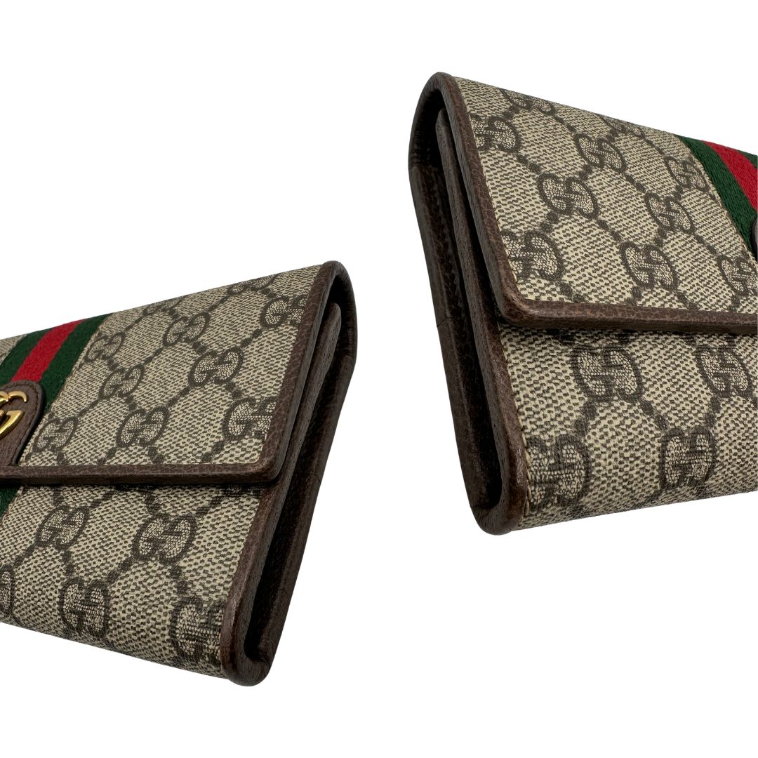 angoli Portafoglio Gucci in canvas beige GG con iconica striscia Web, sul retro presenta stampa Disney, di lusso, originale, ottime condizioni, usato. 