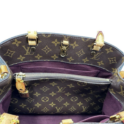 Interno, Borsa Louis Vuitton Montaigne nella versione media in canvas marrone e hardware dorato, indossabile a mano oppure a spalla. Originale, usata, di lusso, in ottime condizioni.