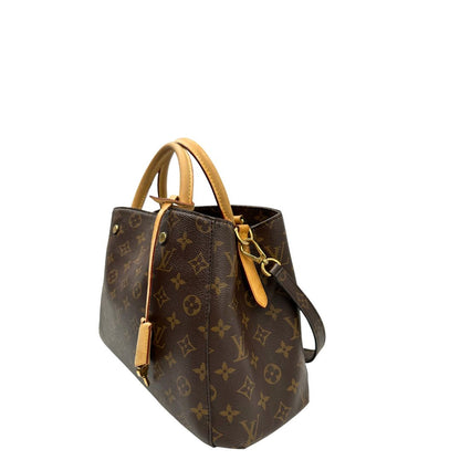 Laterale, Borsa Louis Vuitton Montaigne nella versione media in canvas marrone e hardware dorato, indossabile a mano oppure a spalla. Originale, usata, di lusso, in ottime condizioni.