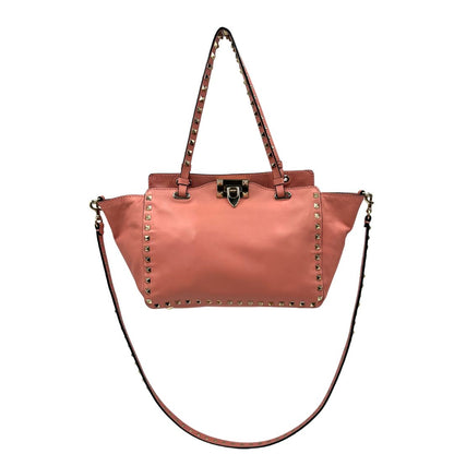 front Borsa V. G. in pelle color rosa salmone impreziosita da borchie piramidali, di lusso, originale, ottime condizioni. 
