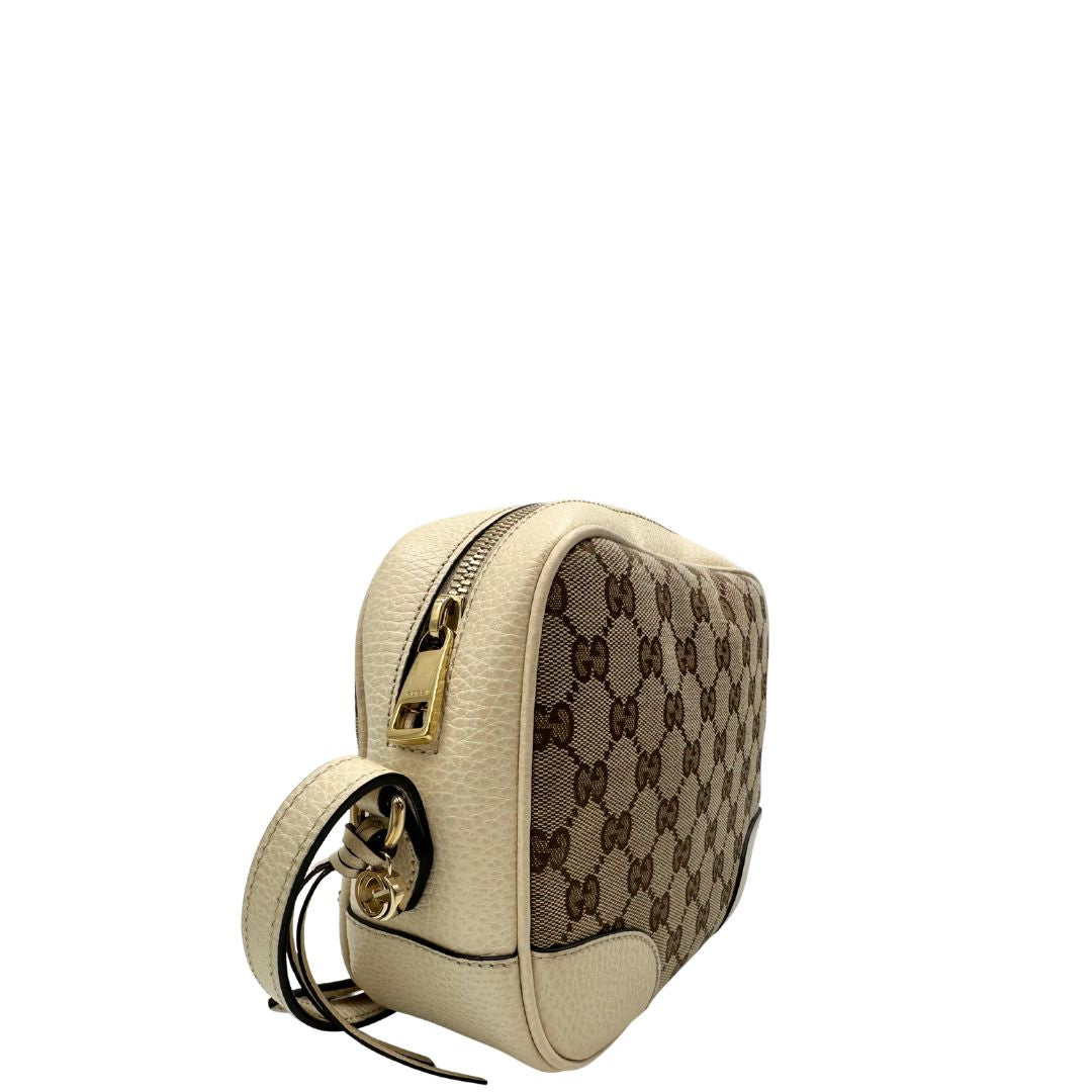 lato Camera Bag Gucci in tessuto GG con finiture in pelle color avorio, di lusso, originale, ottime condizioni, usata.
