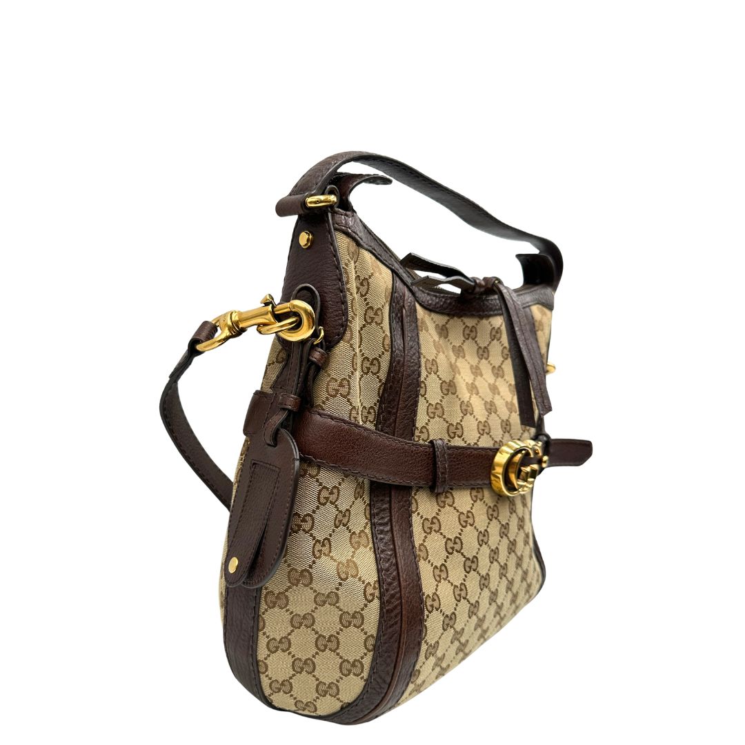 lato  Borsa Gucci in tessuto GG e finiture in pelle marrone, di lusso, originale, ottime condizioni, usata. 