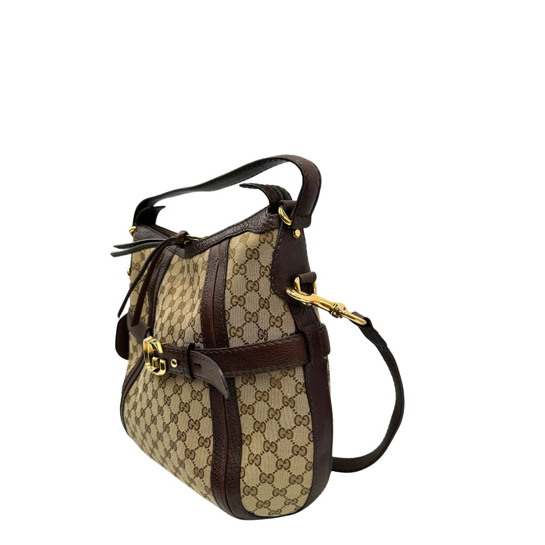 lato  Borsa Gucci in tessuto GG e finiture in pelle marrone, di lusso, originale, ottime condizioni, usata. 