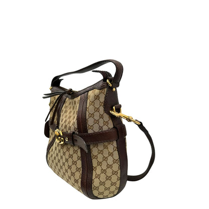 lato  Borsa Gucci in tessuto GG e finiture in pelle marrone, di lusso, originale, ottime condizioni, usata. 