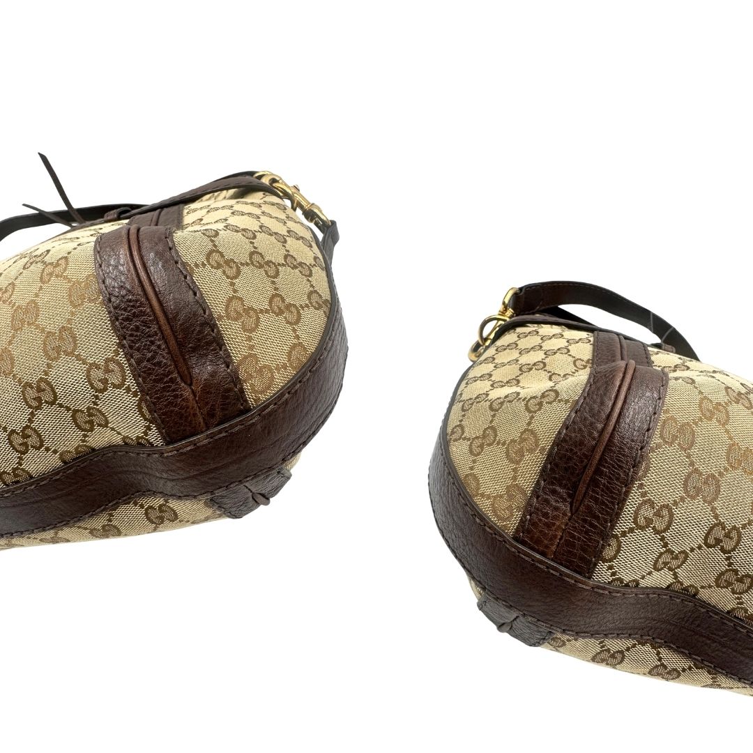 angoli  Borsa Gucci in tessuto GG e finiture in pelle marrone, di lusso, originale, ottime condizioni, usata. 