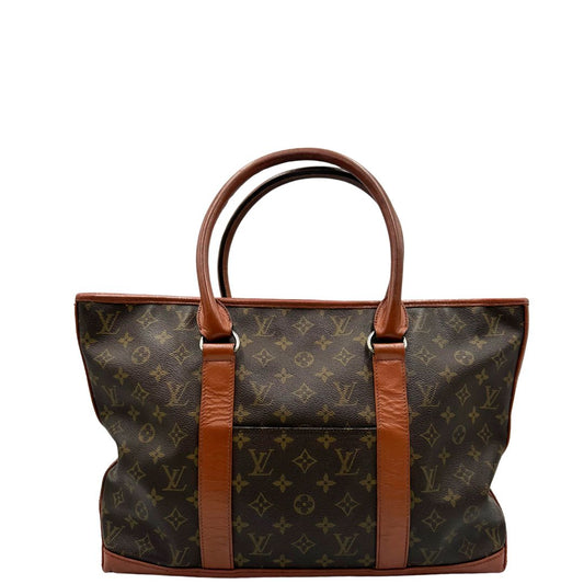 front Borsa Vintage Sac Weekend LV in canvas marrone monogram con finiture in pelle color cognac, indossabile a spalla.&nbsp; 