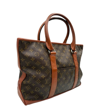 lato Borsa Vintage Sac Weekend LV in canvas marrone monogram con finiture in pelle color cognac, indossabile a spalla.&nbsp; 