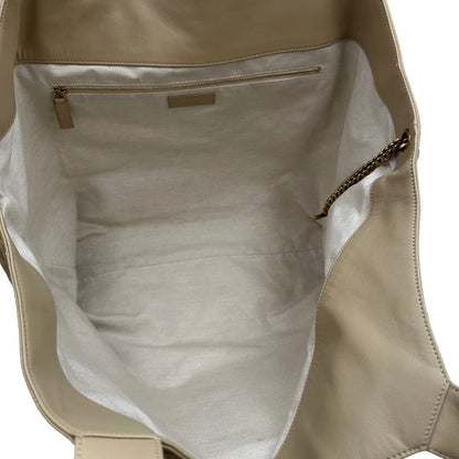 Saint Laurent Icare Maxi Shopping Bag in pelle trapuntata color avorio, impreziosita dall’iconico maxi logo Cassandre dorato frontale, di lusso, originale.