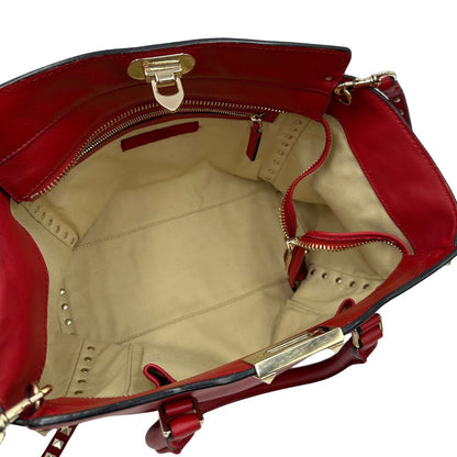 interno Borsa V. G. in pelle rossa impreziosita da borchie piramidali dorate, di lusso, originale, ottime condizioni, usata. 