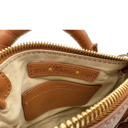 Interno, Borsa Chloè Marcie in pelle martellata color cammello, caratterizzata da lunghe ed evidenti frange decorative. Indossabile a tracolla oppure a mano. Originale, usata, di lusso, in condizioni eccellenti.