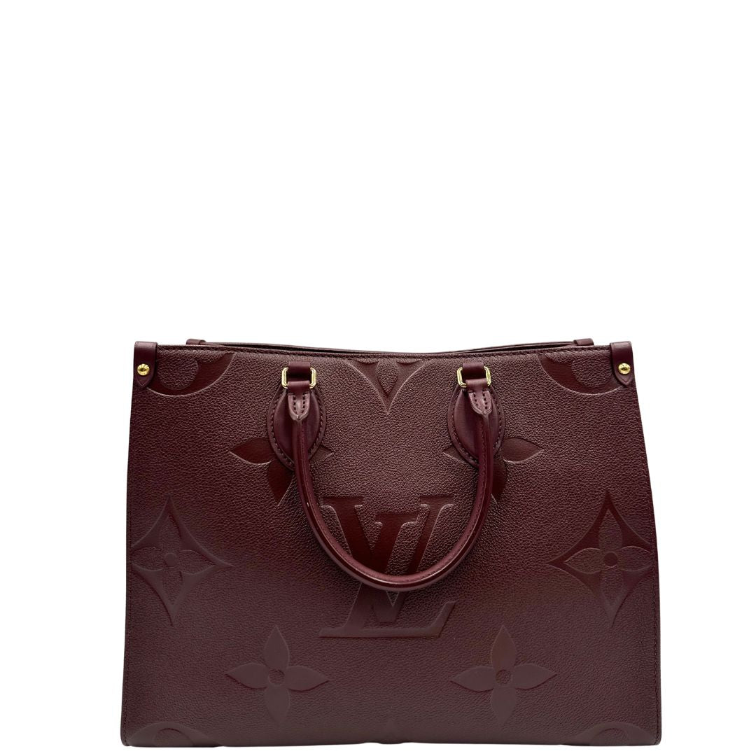 retro  Louis Vuitton OnTheGo nella versione MM in pelle monogram Empreinte color bordeaux, di lusso, originale, ottime condizioni, usata. 