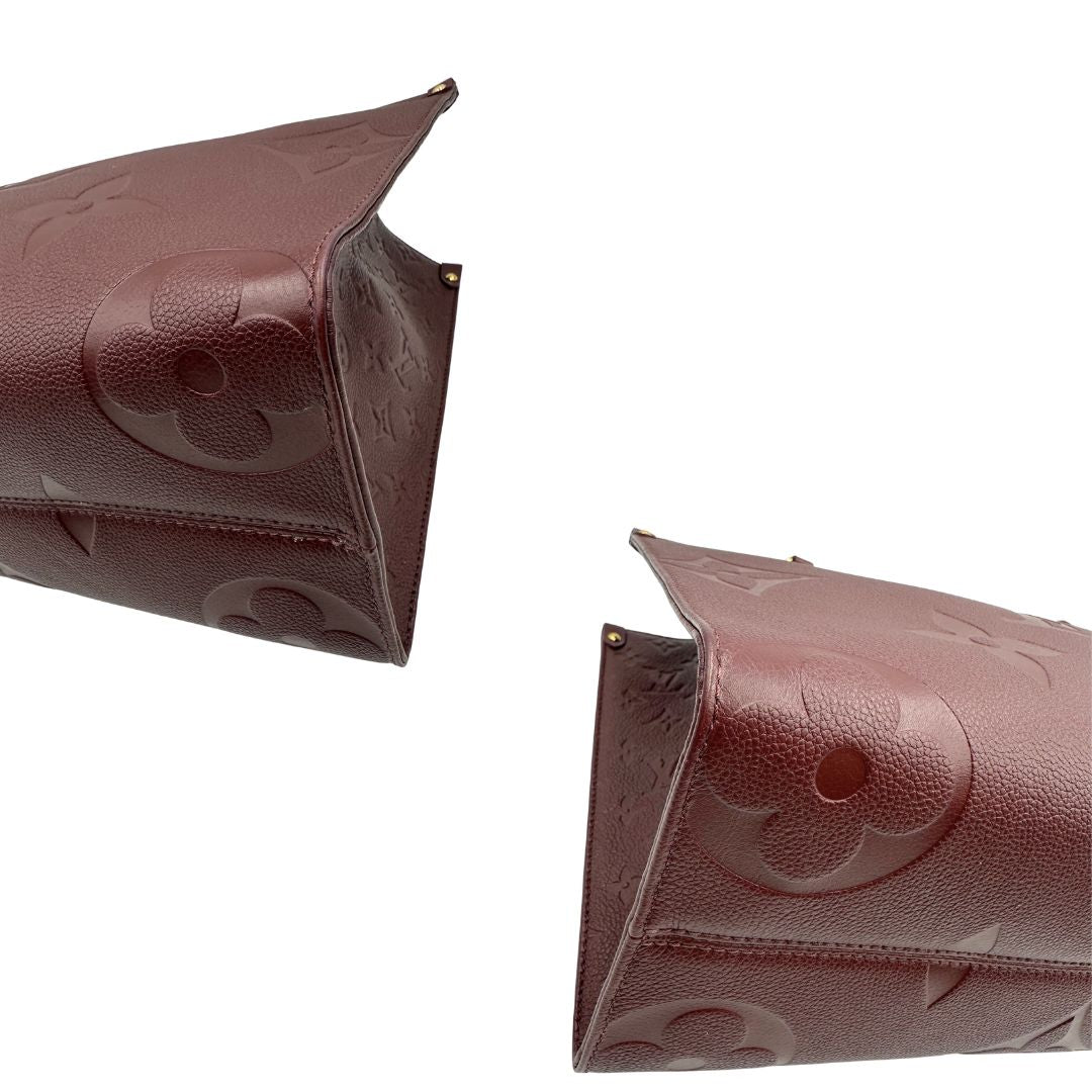angoli  Louis Vuitton OnTheGo nella versione MM in pelle monogram Empreinte color bordeaux, di lusso, originale, ottime condizioni, usata. 
