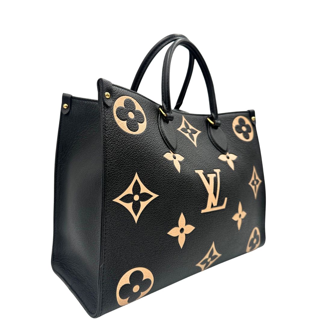 lato Louis Vuitton OnTheGo nella versione MM in pelle monogram Empreinte bicolor, nera e color crema, di lusso, originale, ottime condizioni, usata. 