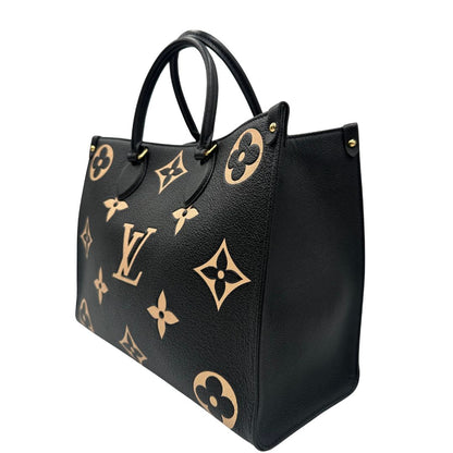 lato Louis Vuitton OnTheGo nella versione MM in pelle monogram Empreinte bicolor, nera e color crema, di lusso, originale, ottime condizioni, usata. 