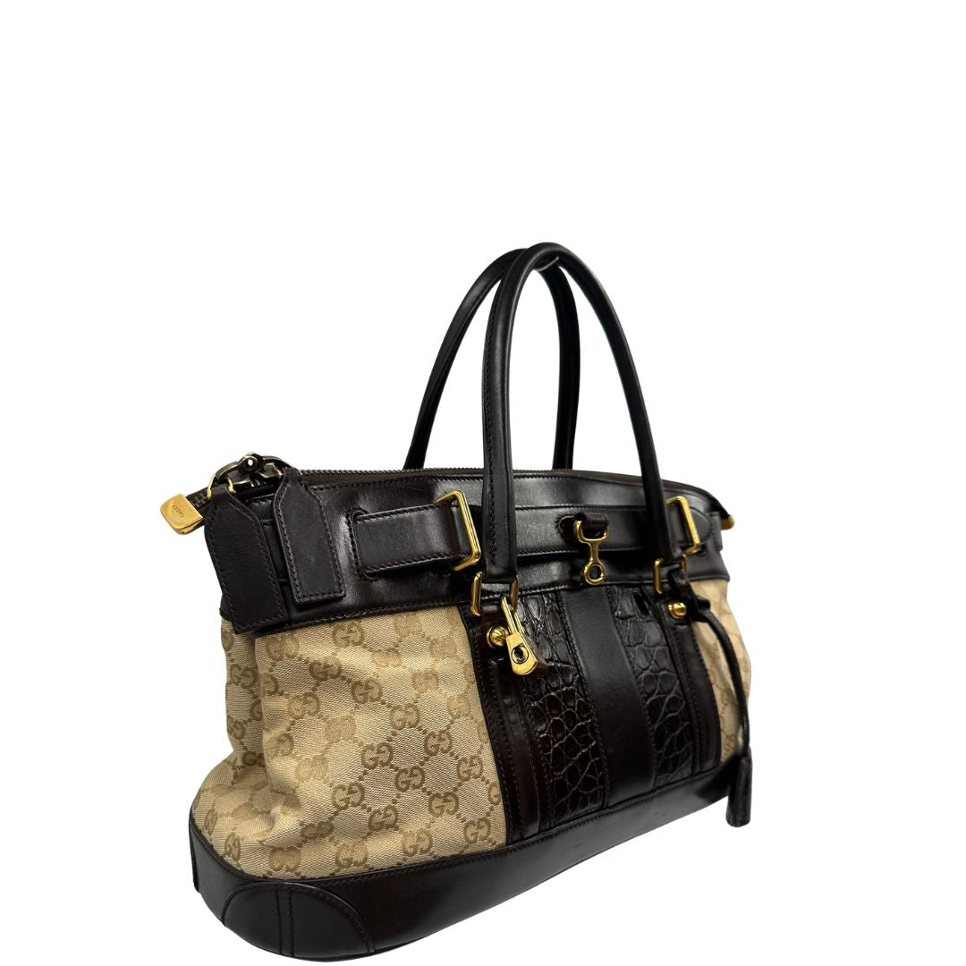 lato Borsa Gucci realizzata in tessuto GG e finiture in pelle color testa di moro, di lusso, originale, ottime condizioni, usata. 