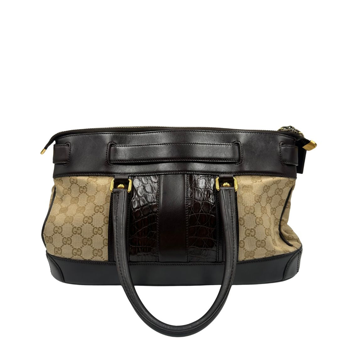 retro Borsa Gucci realizzata in tessuto GG e finiture in pelle color testa di moro, di lusso, originale, ottime condizioni, usata. 