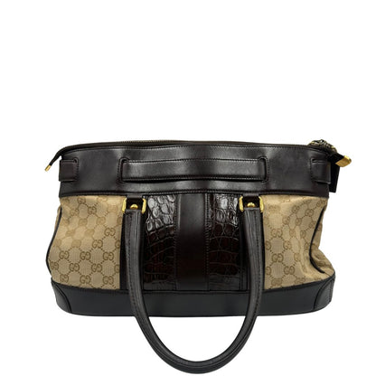 retro Borsa Gucci realizzata in tessuto GG e finiture in pelle color testa di moro, di lusso, originale, ottime condizioni, usata. 