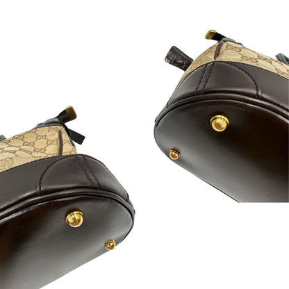 angoli Borsa Gucci realizzata in tessuto GG e finiture in pelle color testa di moro, di lusso, originale, ottime condizioni, usata. 