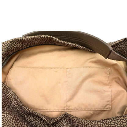 Interno, Borsa Borbonese in tessuto nylon color beige trama occhio di pernice con finiture in pelle bronzo. Indossabile a spalla, a mano, oppure a tracolla. Originale, usata, di lusso, in ottime  condizioni.