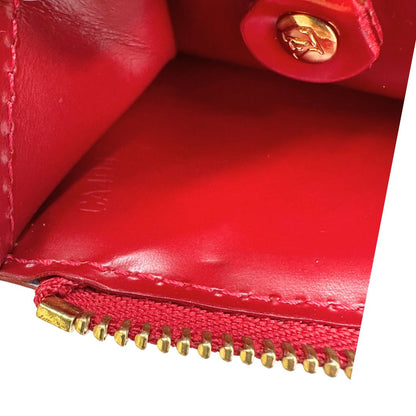 Portamonete Louis Vuitton in pelle vernis rossa con trama monogram empreinte e parti metalliche dorate. Originale, usata, di lusso, in ottime condizioni.