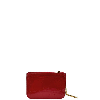 Portamonete Louis Vuitton in pelle vernis rossa con trama monogram empreinte e parti metalliche dorate. Originale, usata, di lusso, in ottime condizioni.