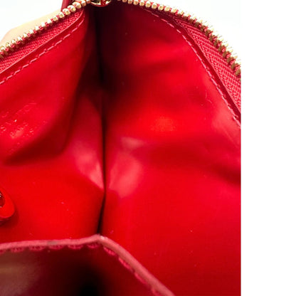 Portamonete Louis Vuitton in pelle vernis rossa con trama monogram empreinte e parti metalliche dorate. Originale, usata, di lusso, in ottime condizioni.