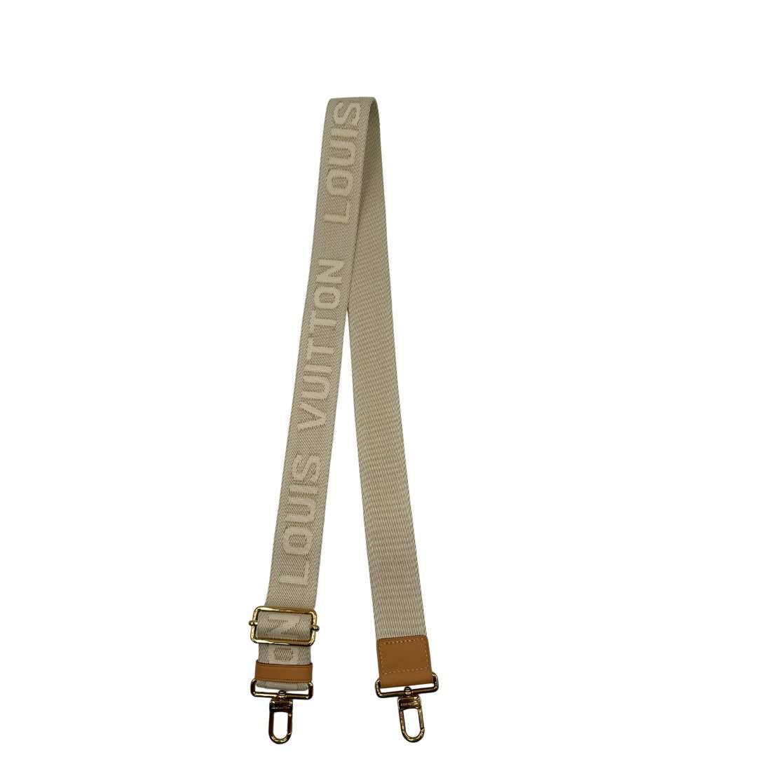 Accessorio tracolla Louis Vuitton realizzato in tessuto beige chiaro con finiture in vacchetta naturale e inserti metallici dorati. Originale, usato, di lusso, in condizioni eccellenti.