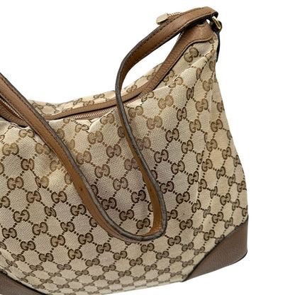 Manico, Borsa Gucci GG in tessuto e pelle marrone; munita di un manico singolo, indossabile a spalla. Originale, usata, di lusso, in buone condizioni.