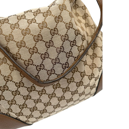 Manico, Borsa Gucci GG in tessuto e pelle marrone; munita di un manico singolo, indossabile a spalla. Originale, usata, di lusso, in buone condizioni.