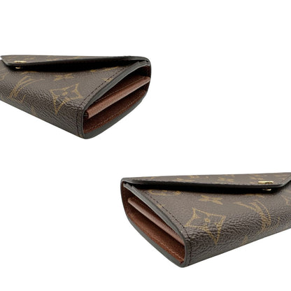 Angoli, Portafoglio Louis Vuitton Sarah in canvas monogrammato marrone, con parti metalliche dorate. Originale, usato, di lusso, in condizioni eccellenti.