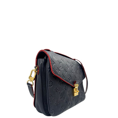 Laterale, Borsa Louis Vuitton Métis in pelle monogram empreinte blu notte con parti metalliche dorate. Munita di un manico e tracolla regolabile con fibbia e amovibile. Originale, usata, di lusso, in ottime condizioni.