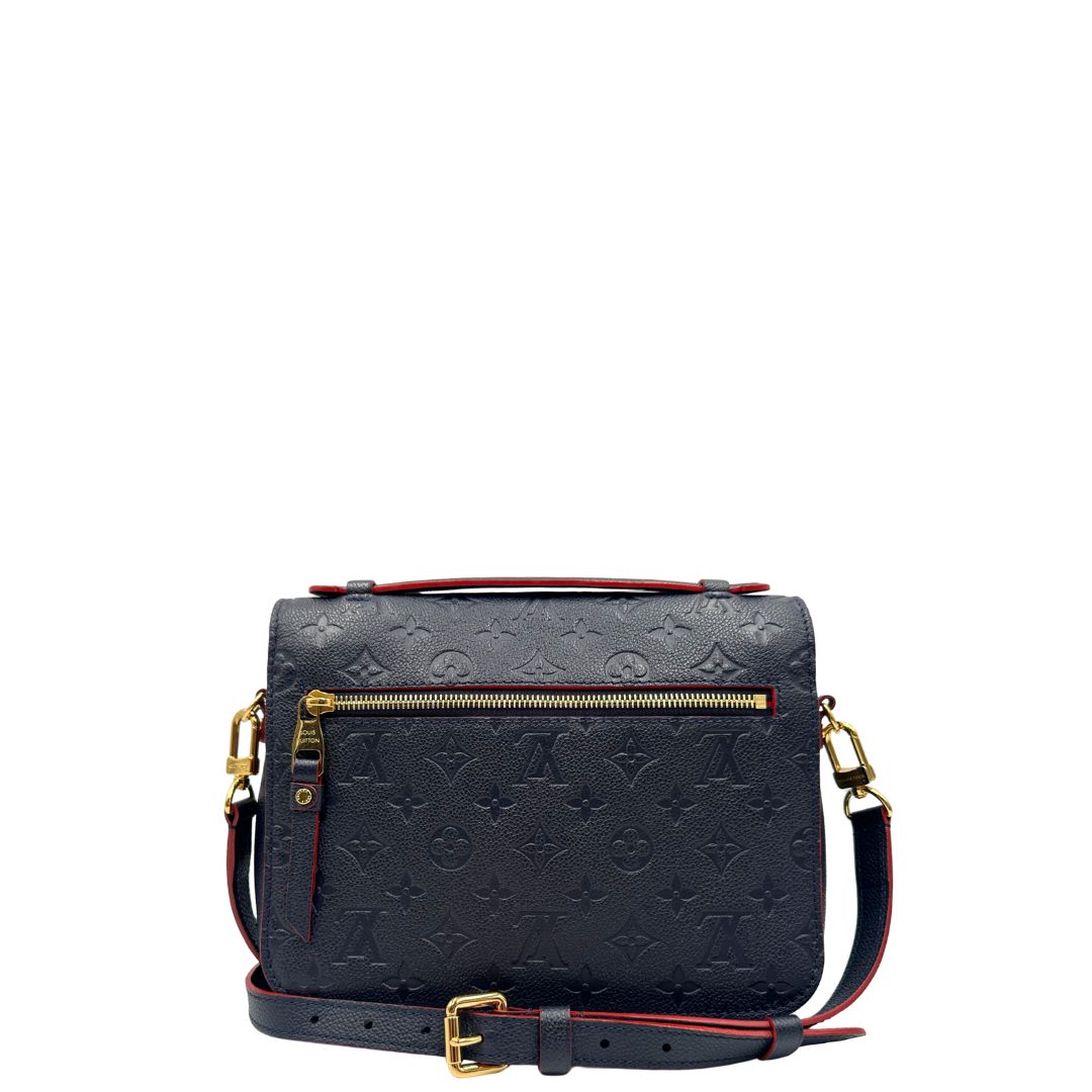 Retro, Borsa Louis Vuitton Métis in pelle monogram empreinte blu notte con parti metalliche dorate. Munita di un manico e tracolla regolabile con fibbia e amovibile. Originale, usata, di lusso, in ottime condizioni.