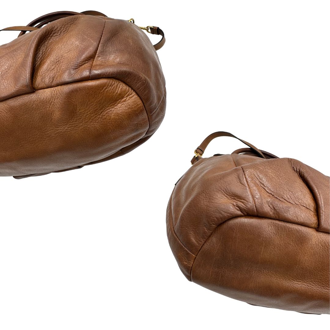 Capiente borsa Prada in pelle marrone con hardware dorato, munita di doppi manici stondati e una tracolla regolabile ed amovibile. Originale, usata, di lusso, in ottime condizioni.