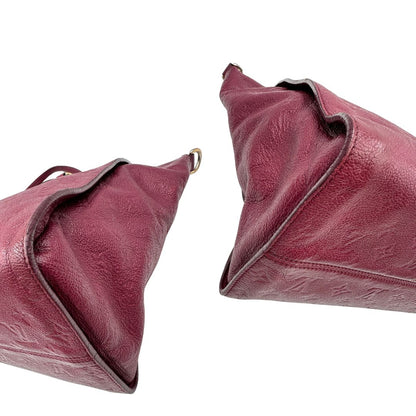 Angoli, Louis Vuitton in pelle monogram empreinte color magenta con hardware dorato , munita di doppi manici. Indossabile a spalla. Originale, usata, di lusso, in ottime condizioni.