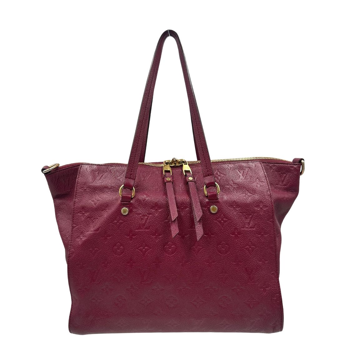 Retro, Borsa Louis Vuitton in pelle monogram empreinte color magenta con hardware dorato , munita di doppi manici. Indossabile a spalla. Originale, usata, di lusso, in ottime condizioni.