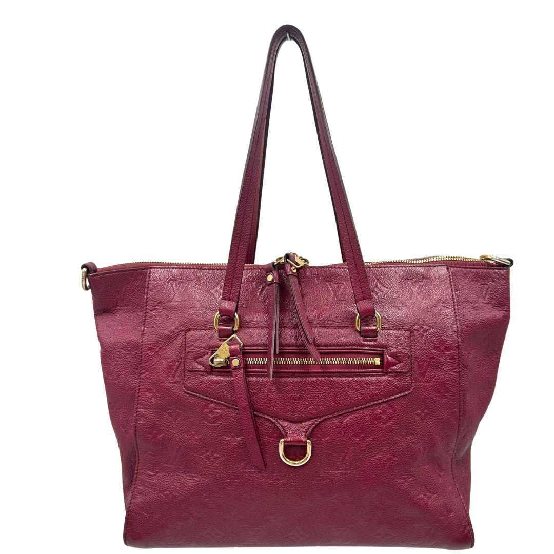 Front, Louis Vuitton in pelle monogram empreinte color magenta con hardware dorato , munita di doppi manici. Indossabile a spalla. Originale, usata, di lusso, in ottime condizioni.