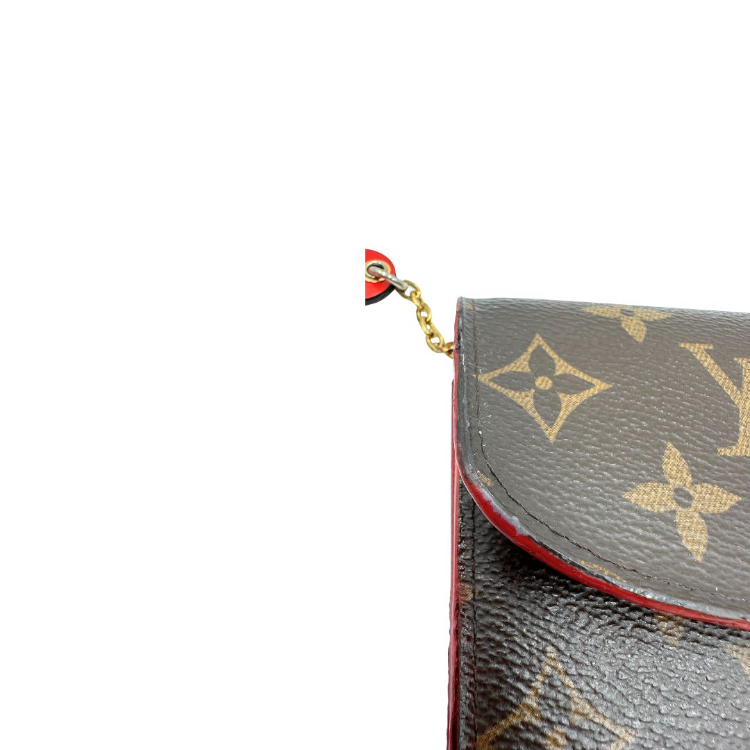 Portafoglio Louis Vuitton Emilie Bloom Flower realizzato in tela Monogram ed è impreziosito da un bottone a forma di fiore. Originale, usato, di lusso, in ottime condizioni.