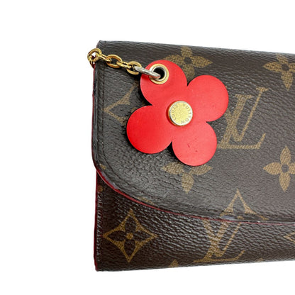 Portafoglio Louis Vuitton Emilie Bloom Flower realizzato in tela Monogram ed è impreziosito da un bottone a forma di fiore. Originale, usato, di lusso, in ottime condizioni.