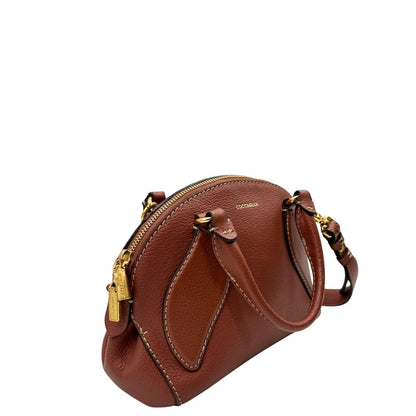 lato Borsa Coccinelle in pelle color marsala con hardware dorato, di lusso, originale, ottime condizioni, usata 