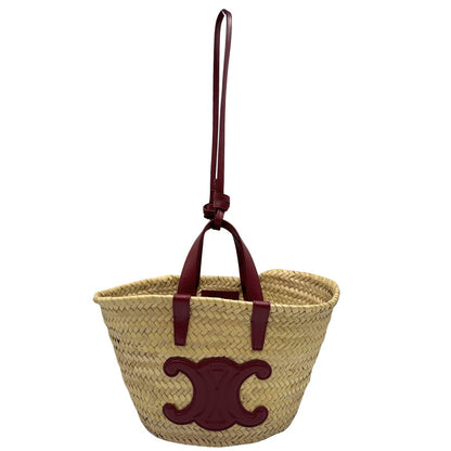 Borsa Celine in rafia beige e finiture in pelle bordeaux, munita di doppi manici e una tracolla in pelle. Indossabile a mano oppure a spalla. Originale, usata, di lusso, in ottime condizioni.