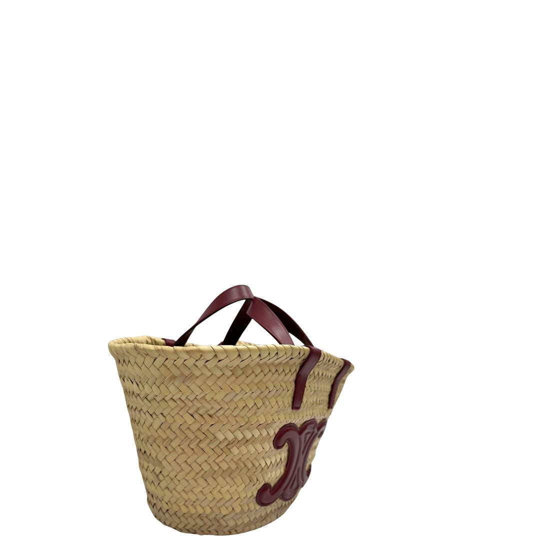 Laterale, Borsa Celine in rafia beige e finiture in pelle bordeaux, munita di doppi manici e una tracolla in pelle. Indossabile a mano oppure a spalla. Originale, usata, di lusso, in ottime condizioni.