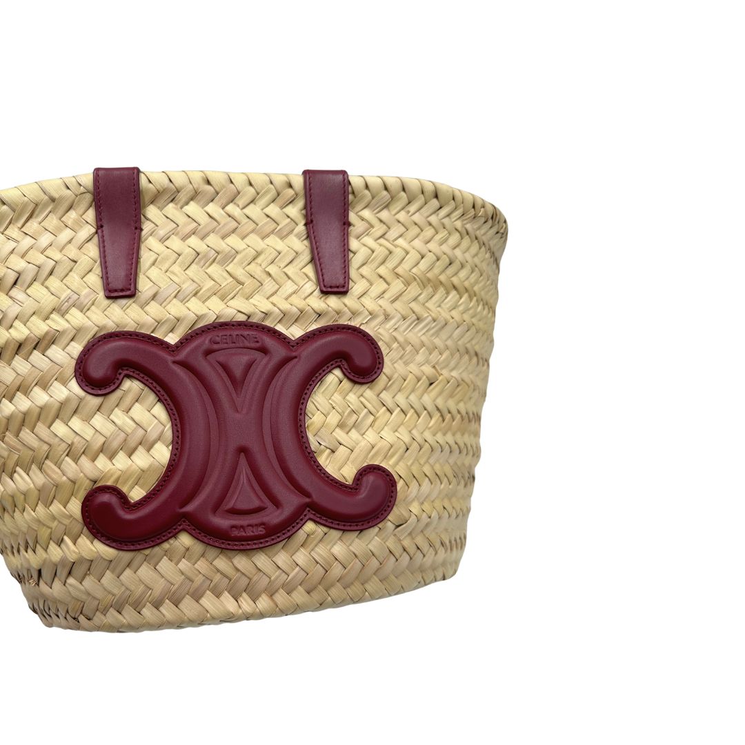 Borsa Celine in rafia beige e finiture in pelle bordeaux, munita di doppi manici e una tracolla in pelle. Indossabile a mano oppure a spalla. Originale, usata, di lusso, in ottime condizioni.